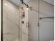 Modern bathroom shower with marble-look walls and a sliding glass door at 702 Compass Point Dr., North Myrtle Beach, SC 29582