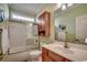 Bathroom featuring tiled floors, tub and shower combination, updated vanity and plenty of natural light at 702 Compass Point Dr., North Myrtle Beach, SC 29582