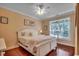 Bright bedroom featuring wood floors, white walls, a ceiling fan and a large sun-filled window at 702 Compass Point Dr., North Myrtle Beach, SC 29582