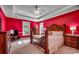 Cozy bedroom with a king-size bed, dresser, and bright red walls at 702 Compass Point Dr., North Myrtle Beach, SC 29582