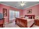 Bedroom with a window, carpet, ceiling fan, and an accent wall with framed artwork at 702 Compass Point Dr., North Myrtle Beach, SC 29582