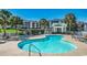 Inviting pool with palm trees and comfortable seating, ideal for enjoying the sun at 702 Compass Point Dr., North Myrtle Beach, SC 29582