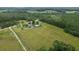 Aerial view of property showcasing the landscape, mature trees, and a dirt road at 721 Old Buck Creek Rd., Longs, SC 29568