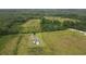 Aerial shot of property showcasing the landscape and mature trees and blue roofed home at 721 Old Buck Creek Rd., Longs, SC 29568