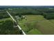 Aerial view of property showcasing the landscape, mature trees, and a dirt road at 721 Old Buck Creek Rd., Longs, SC 29568