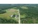 An aerial view showing the main house, surrounding greenery, and long driveway at 721 Old Buck Creek Rd., Longs, SC 29568