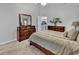 Comfortable bedroom featuring a large bed and wooden dressers at 7228 Guinevere Circle, Myrtle Beach, SC 29588