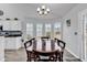 Dining space with wood floors, bright windows, and chandelier lighting at 7228 Guinevere Circle, Myrtle Beach, SC 29588