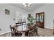 Open dining area features wood floors, chandelier lighting, and sliders to the porch at 7228 Guinevere Circle, Myrtle Beach, SC 29588