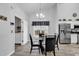 Dining room view showcasing modern lighting and proximity to the laundry room and kitchen at 7228 Guinevere Circle, Myrtle Beach, SC 29588