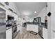 Well-lit kitchen features stainless appliances, white cabinetry, gray backsplash, and wood-look floors at 7228 Guinevere Circle, Myrtle Beach, SC 29588