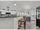 Open kitchen with bar seating, stainless steel appliances, and a view of the dining area at 7228 Guinevere Circle, Myrtle Beach, SC 29588