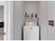 Functional laundry room with a washing machine and storage shelf at 7228 Guinevere Circle, Myrtle Beach, SC 29588