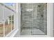 Modern shower with tile surround, glass door, and a window offering natural light at 7228 Guinevere Circle, Myrtle Beach, SC 29588