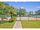 Exterior view of a tennis court, featuring a fence and some trees in the background at 7228 Guinevere Circle, Myrtle Beach, SC 29588