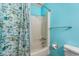 Bright bathroom featuring blue walls and a shower with a charming boat-themed curtain at 800 Egret Circle # 34, Little River, SC 29566