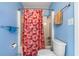 Bathroom with blue walls, shower with patterned curtain, toilet and a roll of toilet paper at 800 Egret Circle # 34, Little River, SC 29566