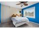 Bedroom with blue accent wall, white wood paneled wall, leafy ceiling fan and carpeted floors at 800 Egret Circle # 34, Little River, SC 29566