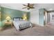 Cozy bedroom with soft green walls, leafy ceiling fan, and closet doors at 800 Egret Circle # 34, Little River, SC 29566