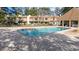 Large community pool surrounded by brick pavers, lounge chairs, and townhomes in the background at 800 Egret Circle # 34, Little River, SC 29566