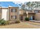 Tan townhouse featuring beautiful brown shutters, a sidewalk entrance, and landscaped garden at 800 Egret Circle # 34, Little River, SC 29566