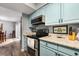 Kitchen showcasing modern appliances, light blue cabinetry, and a dining area at 800 Egret Circle # 34, Little River, SC 29566