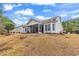 Home exterior featuring a screened-in porch and backyard at 817 Riverwood Ct., Little River, SC 29566