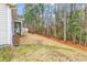 Backyard view with wooded area and exterior of home featuring a screened-in porch at 817 Riverwood Ct., Little River, SC 29566