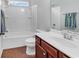 Bathroom with vanity, white cabinets, tile flooring, and a bathtub with a shower at 817 Riverwood Ct., Little River, SC 29566