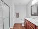 Bathroom featuring a tile floor, white countertop, cherry wood cabinets, and a glass door shower at 817 Riverwood Ct., Little River, SC 29566