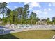 Community swimming pool surrounded by chairs, umbrellas, and green spaces at 817 Riverwood Ct., Little River, SC 29566