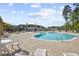 A large swimming pool with lounge chairs and tables for relaxing at 817 Riverwood Ct., Little River, SC 29566