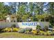 Entrance to Palm Lakes community with lush landscaping and manicured lawns at 817 Riverwood Ct., Little River, SC 29566