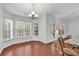 Bright dining area with large windows, a modern chandelier, and easy access to the backyard at 817 Riverwood Ct., Little River, SC 29566