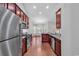 Modern kitchen features stainless steel appliances, granite countertops, and cherry wood cabinetry at 817 Riverwood Ct., Little River, SC 29566