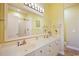 Bright bathroom featuring double sinks, white cabinets, and a large mirror at 817 S Ocean Blvd. # 105, North Myrtle Beach, SC 29582