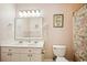 Bathroom featuring double sinks, updated light fixture, and beach-themed wall art at 817 S Ocean Blvd. # 105, North Myrtle Beach, SC 29582