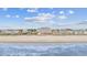 Beautiful beachfront view showcasing the ocean, beach, and a row of colorful beach houses at 817 S Ocean Blvd. # 105, North Myrtle Beach, SC 29582