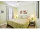 Bright bedroom featuring a ceiling fan, light green walls, and charming wicker furniture at 817 S Ocean Blvd. # 105, North Myrtle Beach, SC 29582