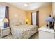 Bright bedroom with white wicker furniture, shell decorations, and a patterned bedspread at 817 S Ocean Blvd. # 105, North Myrtle Beach, SC 29582