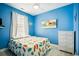 Cheery blue bedroom with a bed, white dresser, beach-themed artwork, and bright decor at 817 S Ocean Blvd. # 105, North Myrtle Beach, SC 29582