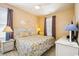 Bedroom featuring a queen bed, beach-themed décor, and large windows at 817 S Ocean Blvd. # 105, North Myrtle Beach, SC 29582