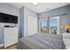 Bedroom featuring a bed, balcony, and white dresser at 817 S Ocean Blvd. # 105, North Myrtle Beach, SC 29582