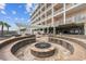 Outdoor fire pit area with brick seating, a pergola, and views of the adjacent building at 817 S Ocean Blvd. # 105, North Myrtle Beach, SC 29582