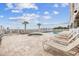 Relaxing pool area with lounge chairs, a hot tub, palm trees, and a partial ocean view at 817 S Ocean Blvd. # 105, North Myrtle Beach, SC 29582