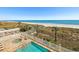 Beautiful pool area with palm trees and ocean views from the balcony at 817 S Ocean Blvd. # 105, North Myrtle Beach, SC 29582