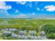 Scenic aerial view of coastal homes near marshland with a bridge leading to oceanfront properties at 89 Enclave Pl., Pawleys Island, SC 29585