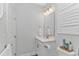 Cozy bathroom with a vanity, mirror, toilet, towel rack, and decorative accents at 89 Enclave Pl., Pawleys Island, SC 29585