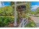 Elegant community sign, 'The Enclave at Pawleys Island', surrounded by greenery and a white fence at 89 Enclave Pl., Pawleys Island, SC 29585