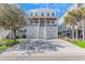 Beautiful beach home with a two-car garage and steps leading to a private porch at 89 Enclave Pl., Pawleys Island, SC 29585